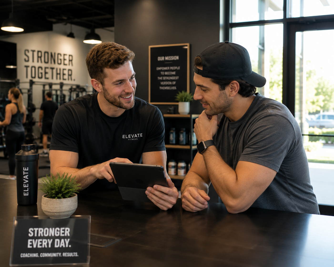 Coach reviewing a membership plan with a member at the gym front desk